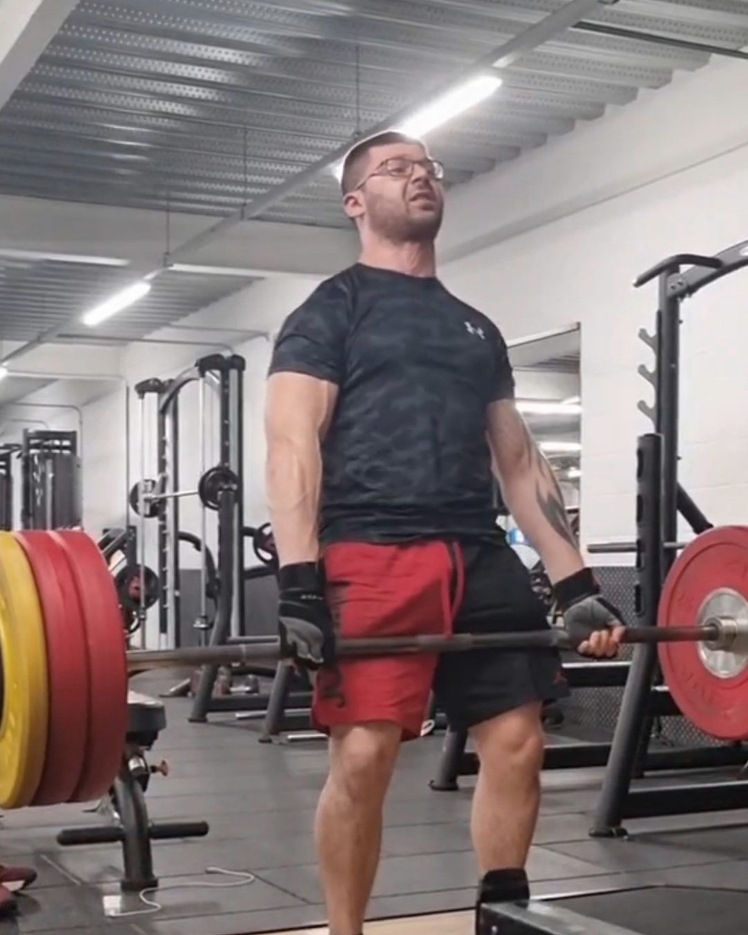 Chris Cachia locking out a heavy barbell deadlift at PureGym Banbury