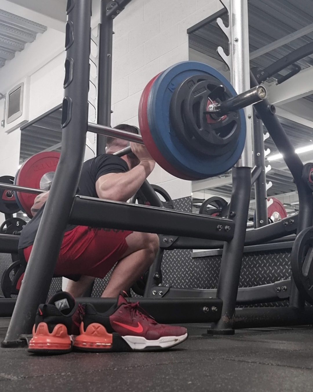 Chris Cachia at the bottom of a heavy barbell back squat at PureGym Banbury